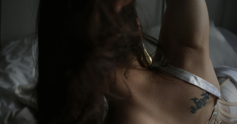 A woman with a tattoo on the back of her neck