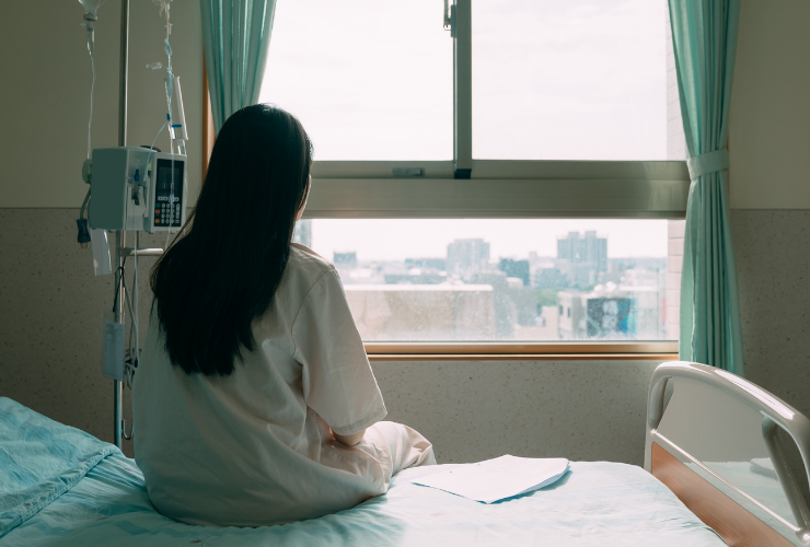 Woman sitting on hospital bed