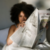 Black woman holding newspaper